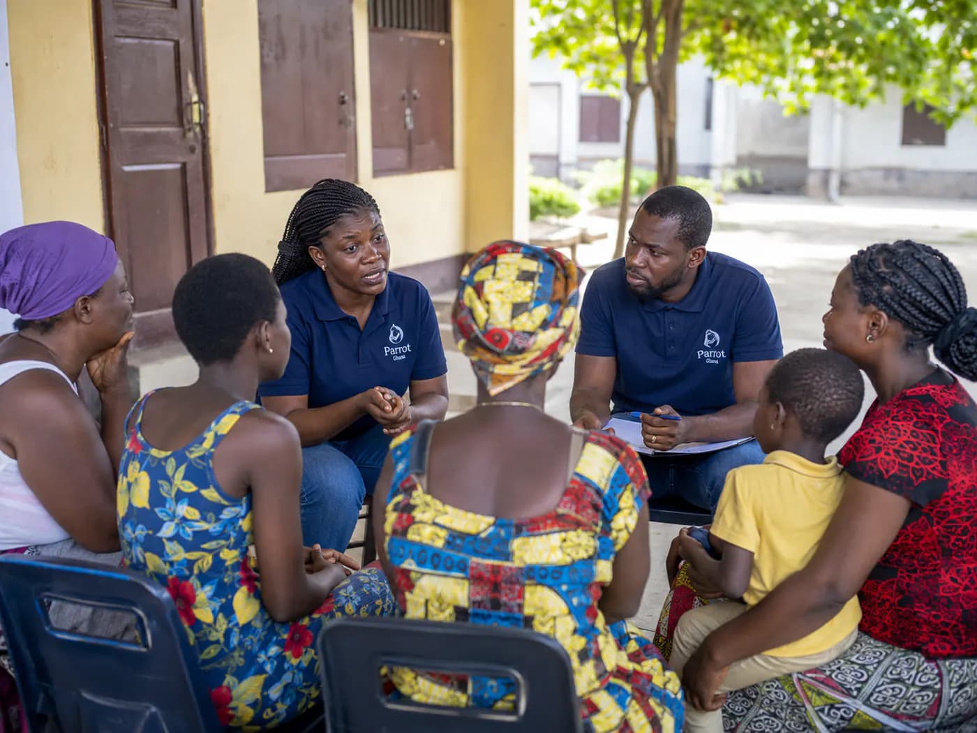 Parrot Ghana team member speaking with a family during a support session.